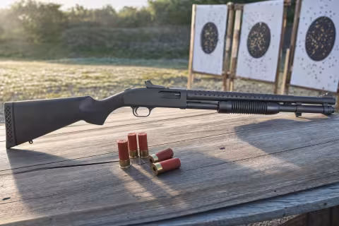 Pumpovacia brokovnica Mossberg 590A1 na stole vonkajšej strelnice.